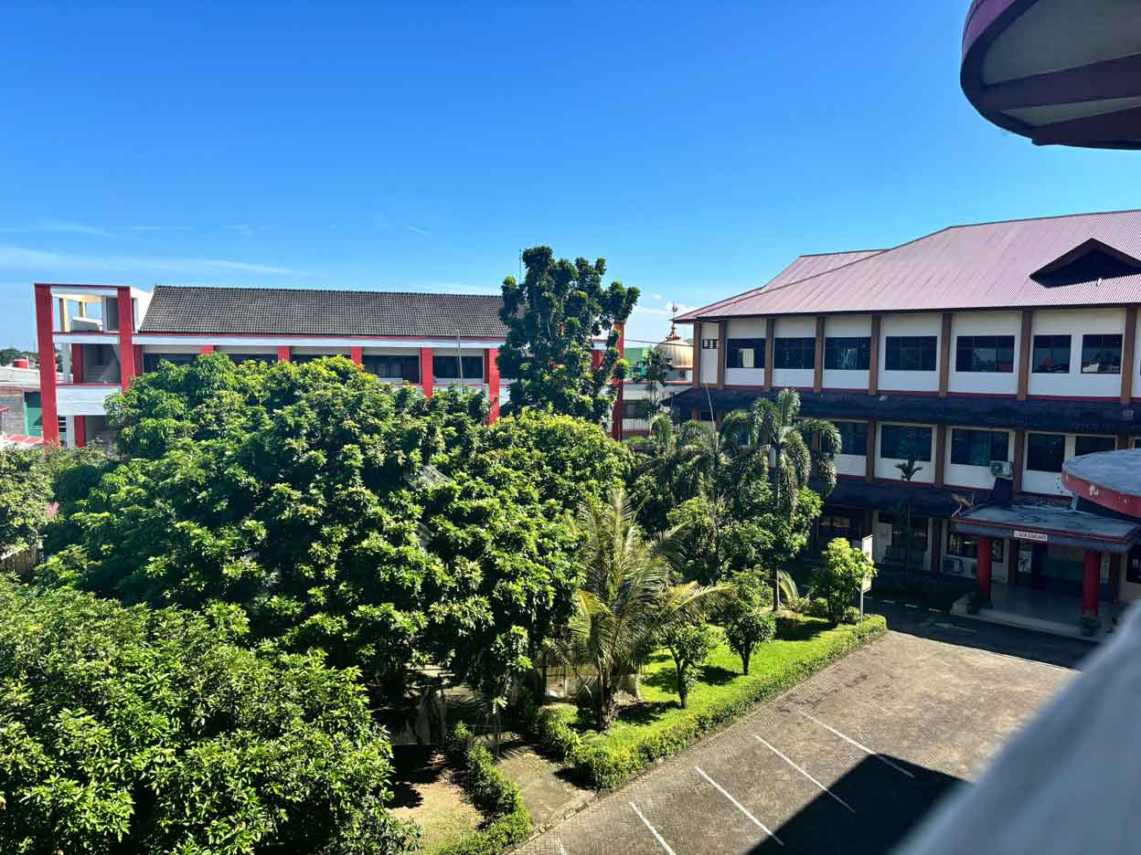 Gedung sekolah dengan arsitektur modern dan taman hijau